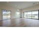 Bright living room with hardwood floors, large windows, and sliding glass doors to the outside at 2779 E Derringer Way, Gilbert, AZ 85295