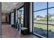 Bright lobby with dark framed picture windows overlooking the manicured green space at 2779 E Derringer Way, Gilbert, AZ 85295