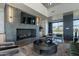 Contemporary lounge featuring a gray tiled fireplace, a view of the outside, and modern furniture at 2779 E Derringer Way, Gilbert, AZ 85295