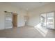 A bedroom with carpet floors, sliding glass doors, and a barn door leading to the bathroom at 2779 E Derringer Way, Gilbert, AZ 85295