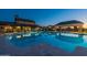 Luxurious community pool reflecting the surrounding building and dusk sky at twilight at 2779 E Derringer Way, Gilbert, AZ 85295