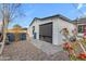 Cozy backyard featuring a stone patio and rock landscaping, complemented by bright bougainvillea at 303 W Hazelwood St, Phoenix, AZ 85013