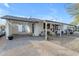 Charming single-story home boasts a covered parking area and a welcoming front porch with seating at 303 W Hazelwood St, Phoenix, AZ 85013