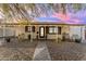 Inviting front of house with a cozy porch featuring rocking chairs and decorative touches at 303 W Hazelwood St, Phoenix, AZ 85013