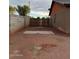 Enclosed backyard with gated access, offering privacy and potential for various outdoor activities and landscaping at 304 E Madison St, Avondale, AZ 85323