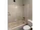 Full bathroom featuring a shower-tub combo with tiled walls and standard fixtures at 304 E Madison St, Avondale, AZ 85323