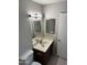 Bathroom with a modern vanity, mirror, and tiled floor, offering a clean aesthetic at 304 E Madison St, Avondale, AZ 85323