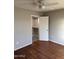 Bedroom with wood flooring and a view into a walk-in closet at 304 E Madison St, Avondale, AZ 85323