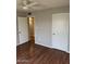 A bright bedroom is enhanced by wood flooring and a view into a hallway at 304 E Madison St, Avondale, AZ 85323