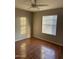 Neutral bedroom features a ceiling fan, window with blinds, and wood-look floors at 304 E Madison St, Avondale, AZ 85323