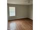 Bedroom with a ceiling fan, wood floors, and a window with natural light at 304 E Madison St, Avondale, AZ 85323