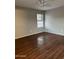 Bedroom with wood floors, a ceiling fan, and a large window at 304 E Madison St, Avondale, AZ 85323