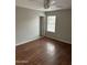 Bright bedroom featuring wood-look flooring, ceiling fan, and a window for natural light at 304 E Madison St, Avondale, AZ 85323