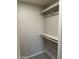 A simple walk-in closet is equipped with a top hanging bar and a single shelf at 304 E Madison St, Avondale, AZ 85323