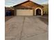 Home featuring a two car garage and desert landscaping at 304 E Madison St, Avondale, AZ 85323