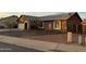 Single-story house featuring neutral stucco, a gray roof, and desert landscaping at 304 E Madison St, Avondale, AZ 85323