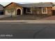 Single-story house featuring neutral stucco, a gray roof, and desert landscaping at 304 E Madison St, Avondale, AZ 85323