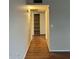 Hallway with laminate flooring and built-in storage shelves at 304 E Madison St, Avondale, AZ 85323