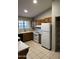 Kitchen featuring tile flooring, oak cabinets, and white appliances at 304 E Madison St, Avondale, AZ 85323