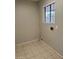 Laundry room with tiled floor, a bright window, and utility connections ready for appliances at 304 E Madison St, Avondale, AZ 85323