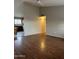 Spacious living room with laminate flooring leading to the kitchen at 304 E Madison St, Avondale, AZ 85323