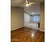 Open-concept living room with tile and laminate flooring, a ceiling fan, and neutral paint at 304 E Madison St, Avondale, AZ 85323