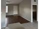 Inviting living room featuring tile and laminate flooring, a ceiling fan, and natural light at 304 E Madison St, Avondale, AZ 85323