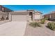 Charming single-story home featuring a two-car garage and low-maintenance desert landscaping at 320 W Phantom Dr, Casa Grande, AZ 85122