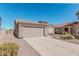 Charming single-story home featuring a two-car garage and low-maintenance desert landscaping at 320 W Phantom Dr, Casa Grande, AZ 85122