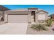 Charming single-story home featuring a two-car garage and low-maintenance desert landscaping at 320 W Phantom Dr, Casa Grande, AZ 85122