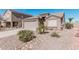 Charming single-story home featuring a two-car garage and low-maintenance desert landscaping at 320 W Phantom Dr, Casa Grande, AZ 85122