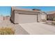 Charming single-story home featuring a two-car garage and low-maintenance desert landscaping at 320 W Phantom Dr, Casa Grande, AZ 85122