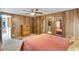 Comfortable bedroom features wood paneling, ceiling fan, and mirrored closet doors at 3330 E Main St # 250, Mesa, AZ 85213