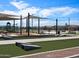 Community common area with a playground, picnic tables, benches, cornhole, and shade structures at 3492 E Audrey Dr, San Tan Valley, AZ 85143