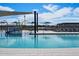 Community pool area with a colorful splash pad, shade structures and many lounge chairs for residents at 3492 E Audrey Dr, San Tan Valley, AZ 85143