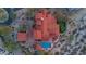 Aerial view of the property showing the red-tile roof, pool, putting green, and surrounding desert landscape at 3756 N Rock Wren Ct, Buckeye, AZ 85396