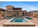 Stunning backyard view featuring a pool, spa, and outdoor living spaces at 3756 N Rock Wren Ct, Buckeye, AZ 85396