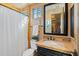 Bathroom with a single sink vanity, a framed mirror, and shower and tub combo at 3756 N Rock Wren Ct, Buckeye, AZ 85396