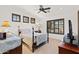 Bedroom showcasing dark wood four-poster bed, custom window treatments, and side table with lamp at 3756 N Rock Wren Ct, Buckeye, AZ 85396