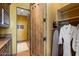 Convenient access to closet, ironing board and plush white robes that enhances the at-home spa experience at 3756 N Rock Wren Ct, Buckeye, AZ 85396