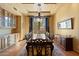 Formal dining room with a large table, buffet, and decorative lighting fixture at 3756 N Rock Wren Ct, Buckeye, AZ 85396