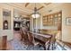 Bright dining room showcasing a large table, chandelier, and views of the living area at 3756 N Rock Wren Ct, Buckeye, AZ 85396