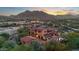 Beautiful exterior showcasing the red tile roof, desert landscaping, and mountain views in a serene setting at 3756 N Rock Wren Ct, Buckeye, AZ 85396