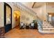 Elegant foyer with iron staircase, tile flooring, and decorative wall accents at 3756 N Rock Wren Ct, Buckeye, AZ 85396