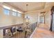 Upstairs hallway with an ornate hanging light fixture and tile floors at 3756 N Rock Wren Ct, Buckeye, AZ 85396