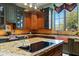 Close up on a kitchen island with cooktop, custom cabinets, and a copper sink by the window at 3756 N Rock Wren Ct, Buckeye, AZ 85396