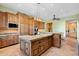 A kitchen with custom wood cabinetry, granite countertops, and modern stainless steel appliances at 3756 N Rock Wren Ct, Buckeye, AZ 85396