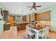 A spacious kitchen featuring wood cabinets, granite countertops, stainless appliances, and an eat-in dining area at 3756 N Rock Wren Ct, Buckeye, AZ 85396