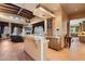 Open-concept living space with seamless transition to the kitchen with bar seating and view to the living room at 3756 N Rock Wren Ct, Buckeye, AZ 85396