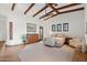 Spacious main bedroom featuring wooden ceiling beams, tiled floors and a dresser at 3756 N Rock Wren Ct, Buckeye, AZ 85396